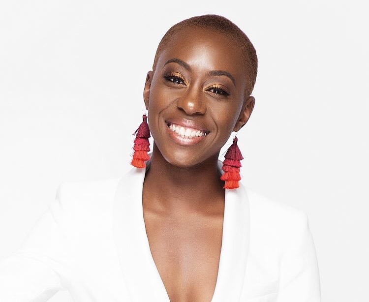 Tasia Franklin, white shirt and red earrings with fade cut and a bright smile